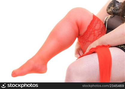 Plus size big chubby woman puts on red nylon stockings. Woman plus size puts on red nylon stockings