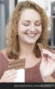 Plus Size Woman Enjoying Eating Bar Of Chocolate