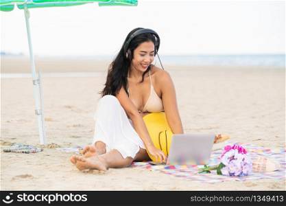 Plus size young woman sitting on tropical sand beach in summer. Holiday travel vacation.. Plus size young woman sitting on the beach.