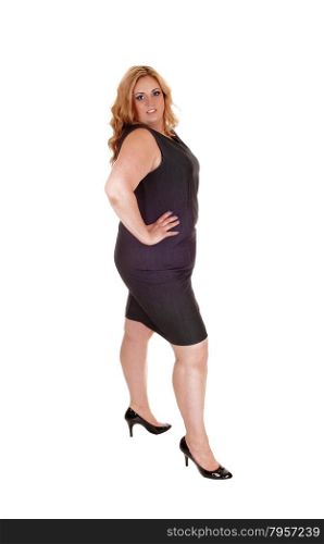 Plus size young woman standing isolated for white background withher hand on her hip, in high heels.