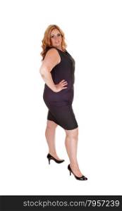 Plus size young woman standing isolated for white background withher hand on her hip, in high heels.