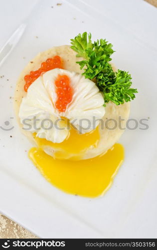 poached eggs in a nest of mashed potatoes with greens and caviar