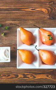 Poached pears with cream cheese decorated with fresh mint