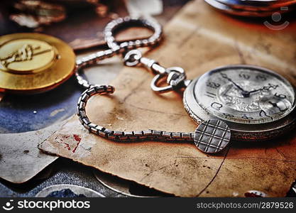 pocket clock with chain on background of old photos