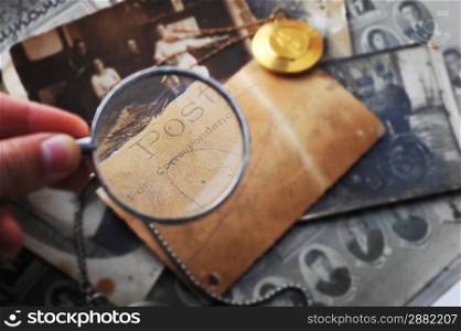 pocket clock with chain on background of old photos
