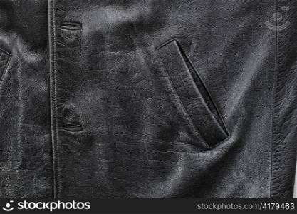 Pocket detail of an old black worn leather jacket
