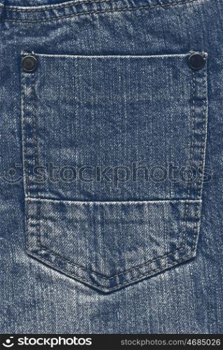 Pocket of blue jeans. Back pocket of blue jeans close-up as background.