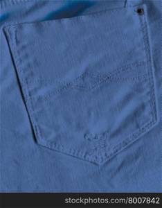 Pocket of blue jeans. Back pocket of jeans close-up as background.