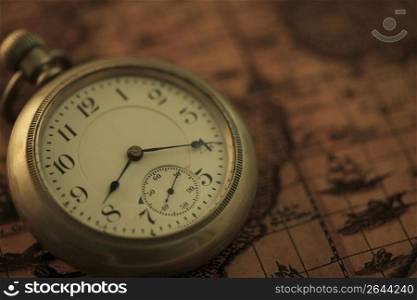 Pocket watch and old map