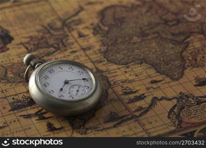Pocket watch and old map