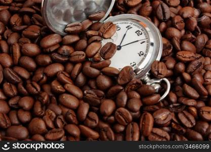 pocket watch in a pile of coffee beans