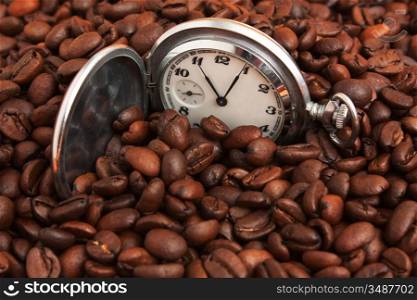 pocket watch in a pile of coffee beans