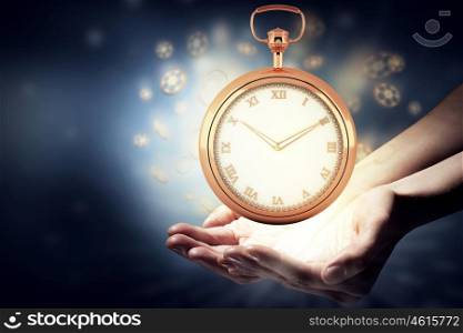 Pocket watch sign. Close up image of human hands holding pocket watch