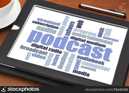 podcast word cloud on a digital tablet with a cup of coffee - internet radio concept