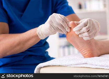 Podiatrist treating feet during procedure