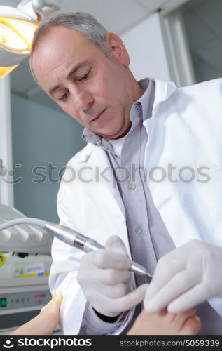 podiatrist working on a patient in a clinic