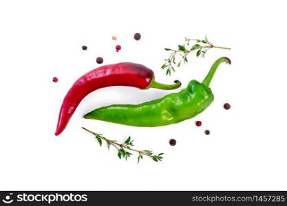 Pods of green and red hot pepper, two sprigs of thyme and peas of colored pepper isolated on a white background