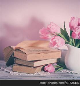 Poem still life with books and pink tulips. Poem still life