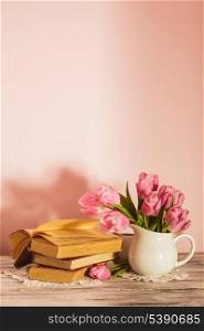 Poem still life with books and pink tulips with copy space. Teacher&rsquo;s day.