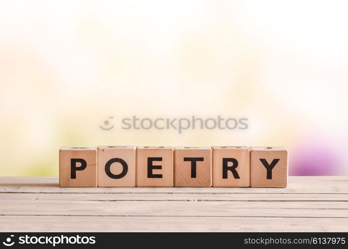 Poetry word made of wooden cubes on a desk