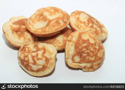 Poffertjes, Dutch small, fluffy pancakes, served with powdered sugar and butter.