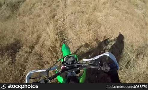 Point of View: Enduro racer on dirt bike riding off-road