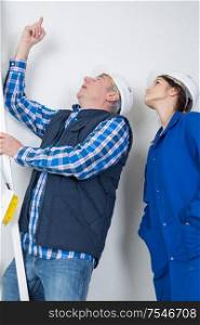 pointing at the leak on the ceiling