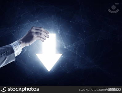 Pointing right direction. Businessman on dark background taking with fingers arrow icon