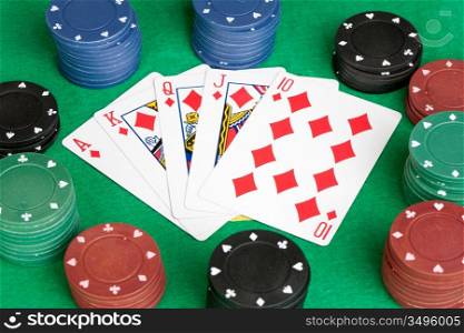 Poker cards with straight flush and many chips