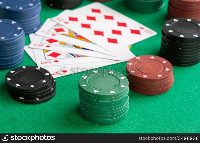 Poker cards with straight flush and many chips