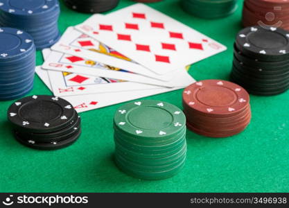 Poker cards with straight flush and many chips