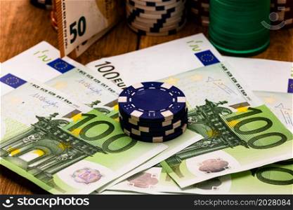 Poker casino chips and money close up. Casino concept, risk, chance, good luck or gambling. Detail of casino chips, EURO, US dollars