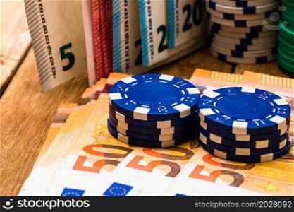 Poker casino chips and money close up. Casino concept, risk, chance, good luck or gambling. Detail of casino chips, EURO, US dollars