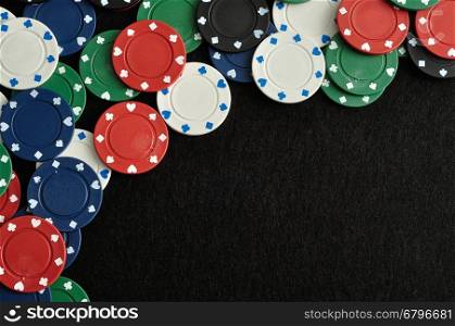 Poker chips forming a border with a black background