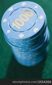 Poker chips piled on a poker table (close up/depth of field)