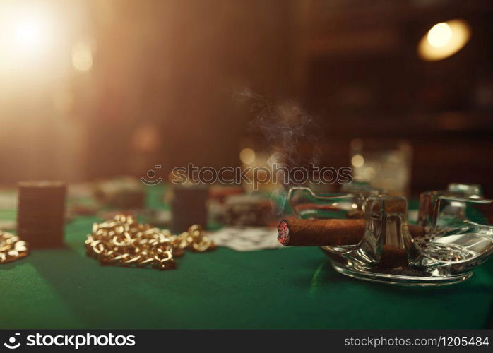 Poker concept, cards and chips on gaming table closeup, whiskey and cigar in casino, nobody. Games of chance. Gambling house business. Poker concept, cards and chips closeup