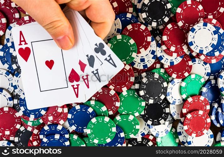 Poker hand over poker chips background. Casino concept for business, risk, chance, good luck or gambling