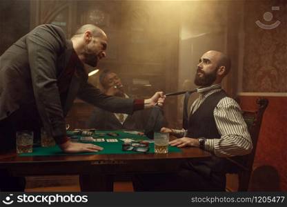 Poker player grabbed his opponent&rsquo;s tie, sharper in casino, risk. Games of chance addiction. Men with whiskey and cigars in gambling house. Poker player grabbed his opponent&rsquo;s tie, casino