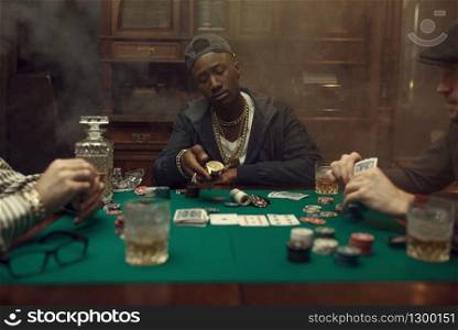 Poker player makes a bet, casino. Games of chance addiction. Man leisures in gambling house, gaming table with green cloth. Poker player makes a bet, casino