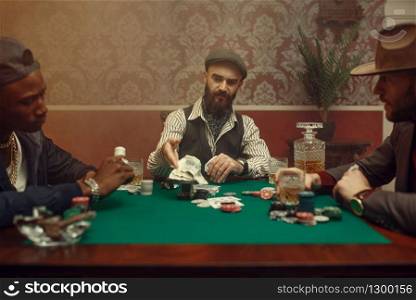 Poker player makes the bet, casino. Games of chance addiction. Man leisures in gambling house, gaming table with green cloth. Poker player makes the bet, casino
