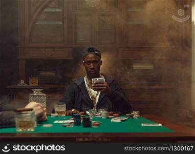 Poker player plays in casino. Games of chance addiction. Man leisures in gambling house, gaming table with green cloth. Poker player plays in casino