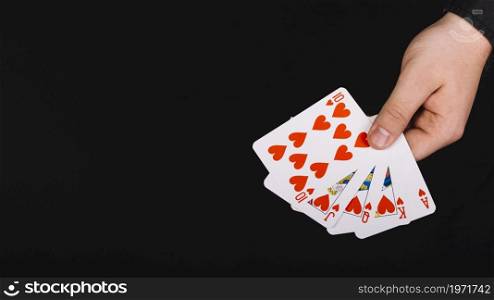 poker player s hand royal flush heart black background. High resolution photo. poker player s hand royal flush heart black background. High quality photo