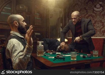 Poker player with gun, showdown with opponents in casino, risk. Games of chance addiction. Men with whiskey and cigars in gambling house