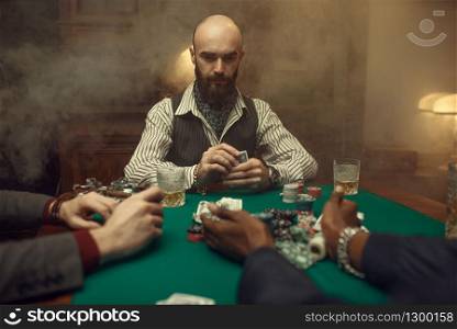 Poker players with cards and chips in casino. Games of chance addiction, gambling house. Men leisures with whiskey and cigars. Poker players with cards and chips in casino