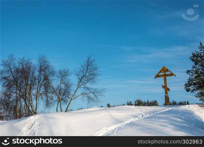 Poklonniy cross on Holy Irinarkhovo spring in a sunny winter day near the village of Khaurovo, Borisoglebsky district, Yaroslavl region, Russia.
