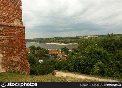 Poland, a view from the top of the castle walls from the fourteenth century, the houses and the Vistula river in Kazimierz Dolny (Kazimierz on the Vistula). Editorial. Vertical view.