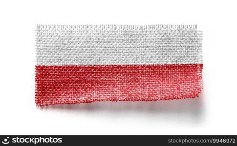 Poland flag on a piece of cloth on a white background.. Poland flag on a piece of cloth on a white background