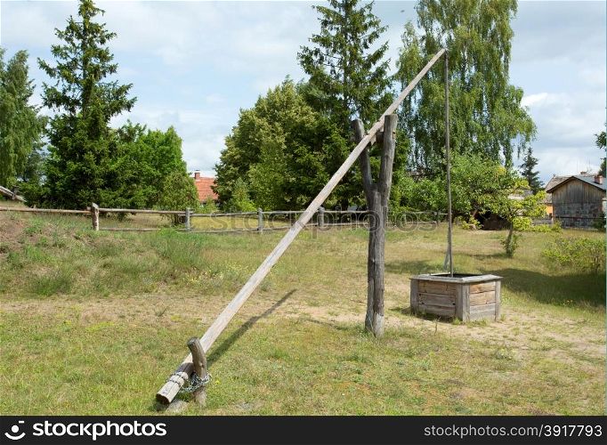 Poland in summer.Outdoor museum in Wdzydze on Pomerania.Historic well and water crane in Poland.Horizontal view