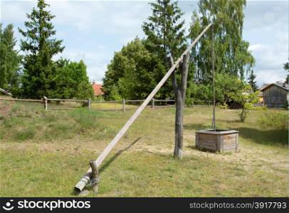 Poland in summer.Outdoor museum in Wdzydze on Pomerania.Historic well and water crane in Poland.Horizontal view