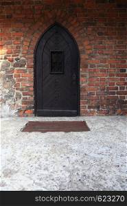 Poland old castle Nidzica old teutonic. Old Wooden Door on Grunge Brick Wall